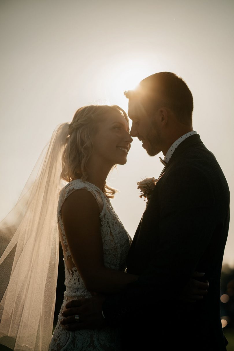 Newlyweds kissing at sunset, reel couple. Wedding film and videography.